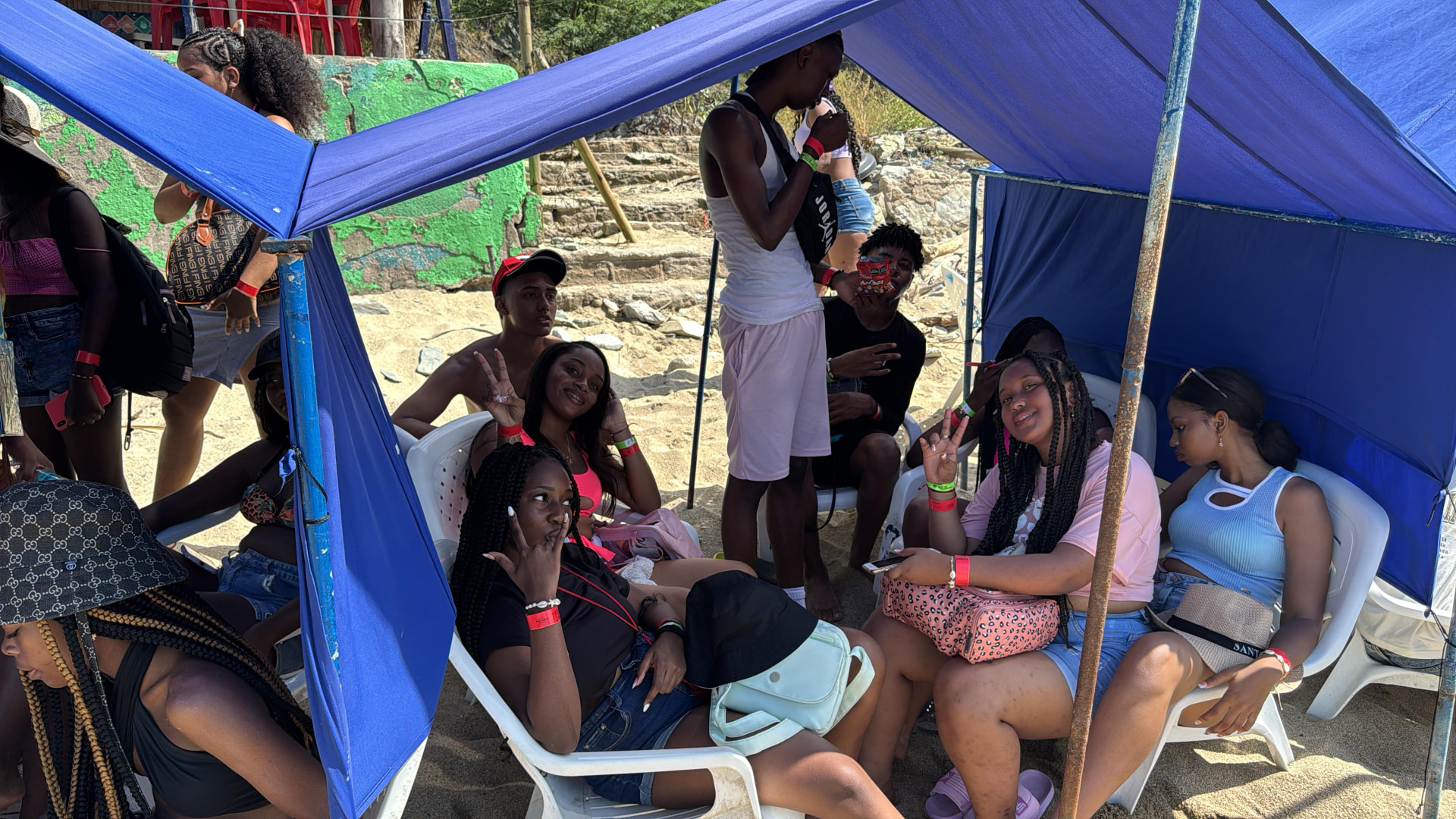 Estudiantes compartiendo en sillas de playa bajo carpas en Santa Marta 2024